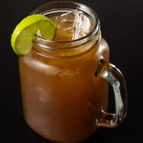 A refreshing glass of papelón con limón, a popular Venezuelan beverage made with panela and lime